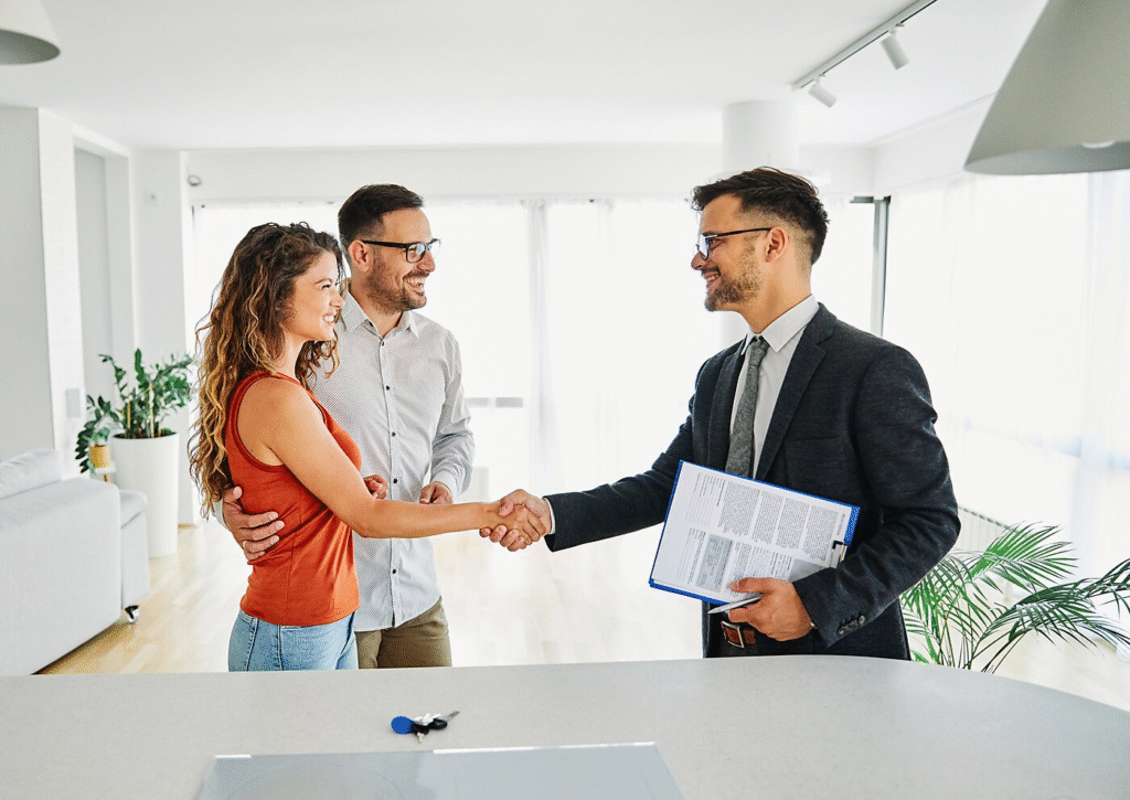 “Professional advisor shakes hands with a smiling couple across a desk in a bright office, holding documents, symbolizing a successful financial or tax consultation.”